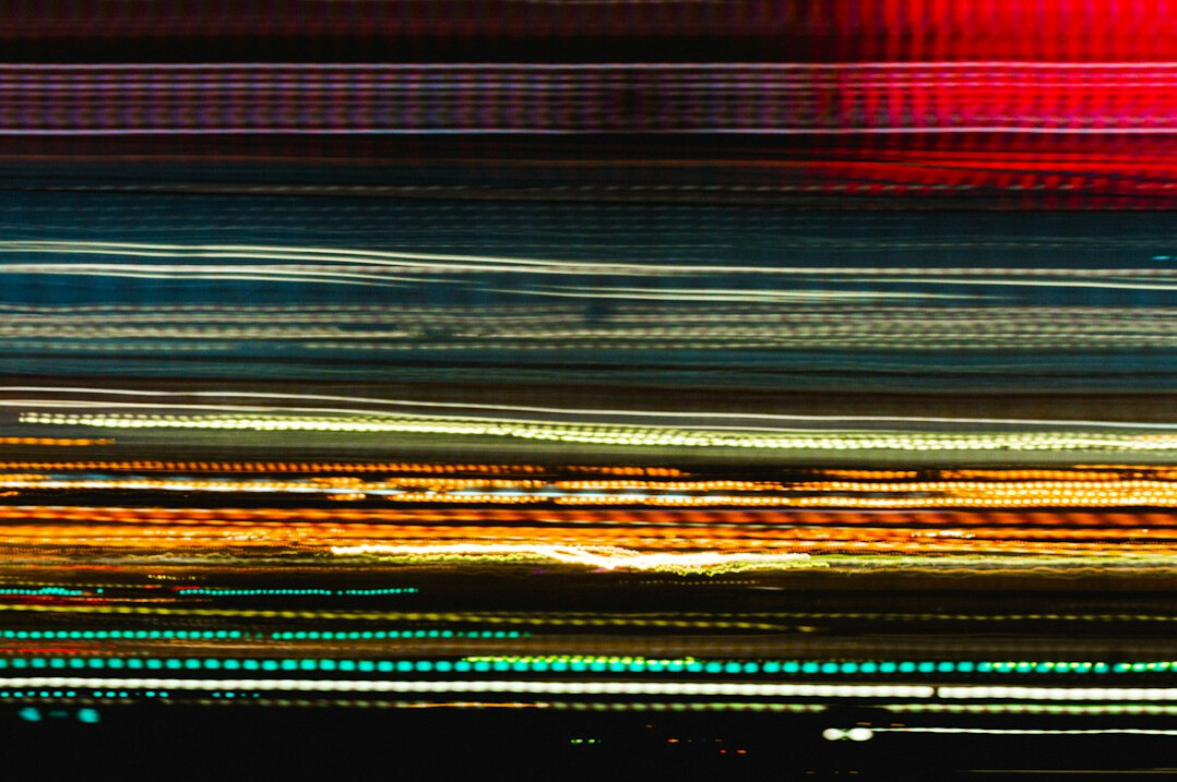 Laptop screen showing colorful lines of programming code