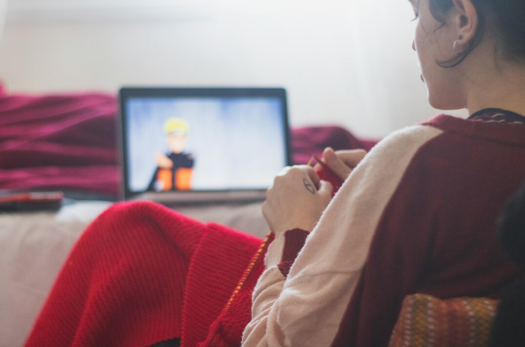 person watching tech video on laptop