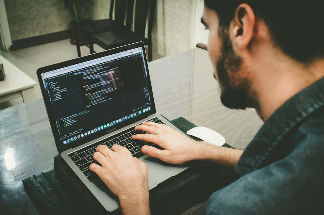 developer coding on laptop
