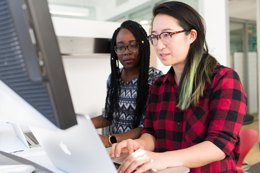 diverse students coding together